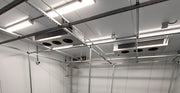 Cleanroom with white walls, ceiling panels, and floor.