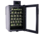Cool Cure with glass door open, displaying small plants on shelves.