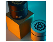 Two cylindrical containers with floral designs on a blue background, featuring the brand 'Flower Mill'.
