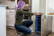 Person with purple hair interacting with a Cool Cure in a kitchen.