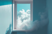 Window with view of fluffy white clouds against a blue sky