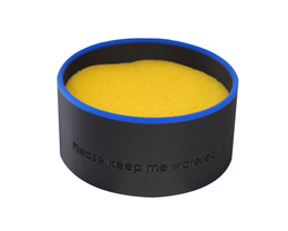 Yellow sponge in a black container with blue rim on a white background