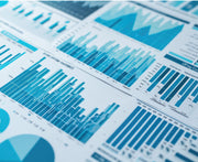 Sheet of paper with various blue statistical charts and graphs.
